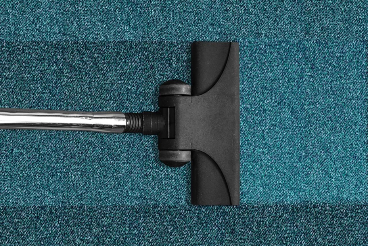 A vacuum cleaner cleaning a fabric surface.