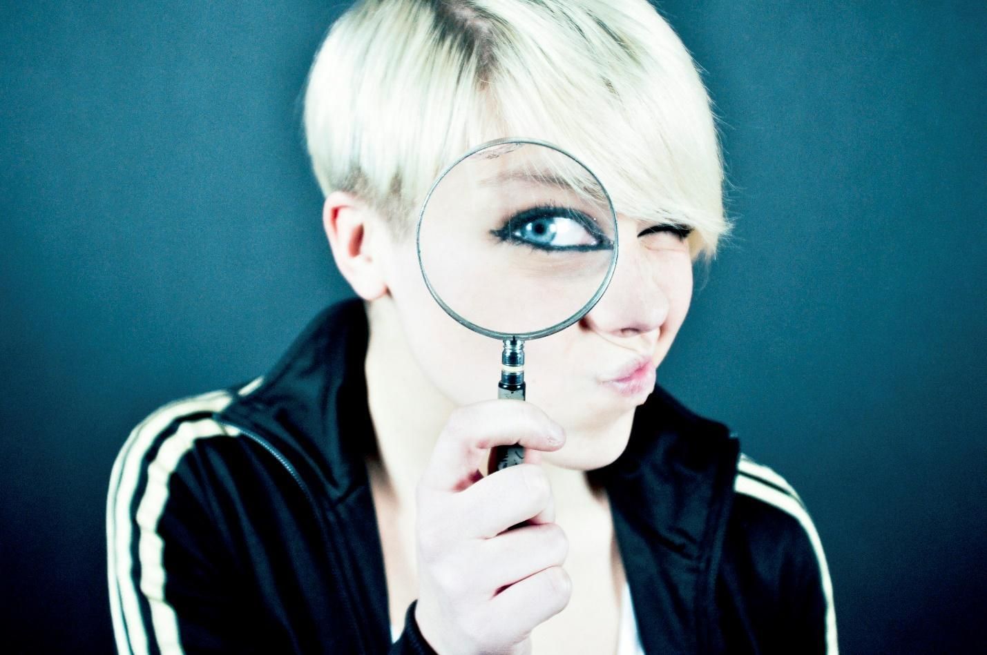 A person looking through a magnifying glass.