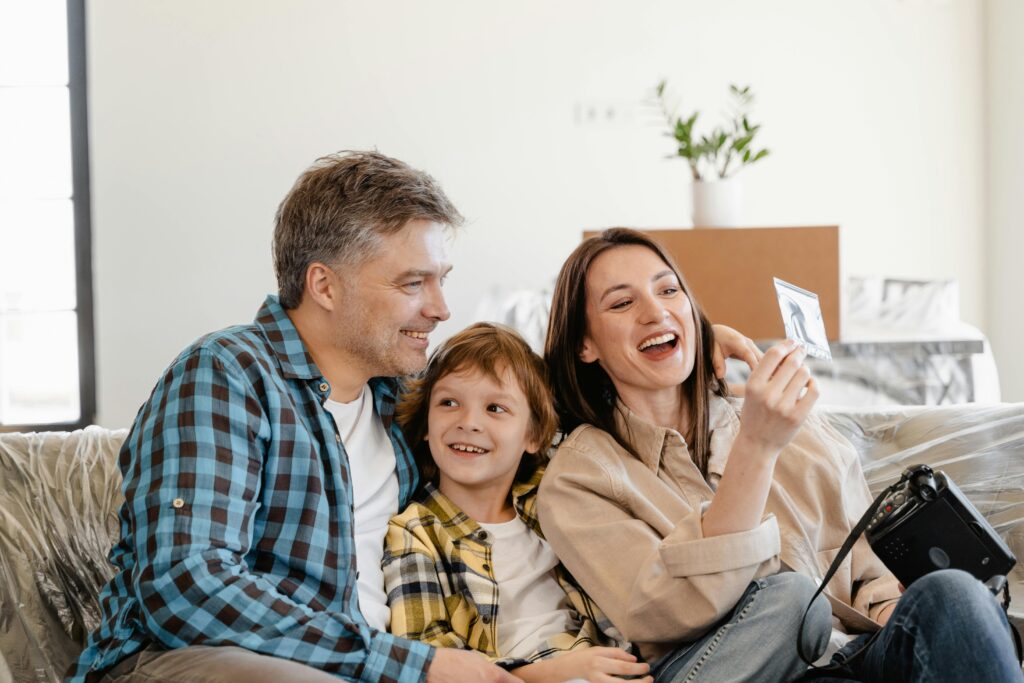 A family looking at pictures together on their couch
